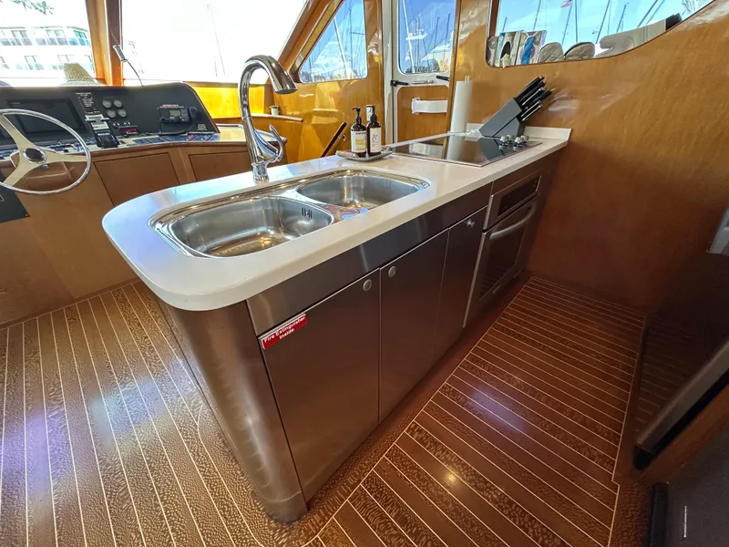 Slide: The Image of Interior of 2000 Mikelson 61 Sportfisher yacht with modern kitchen and dual sink. - 22