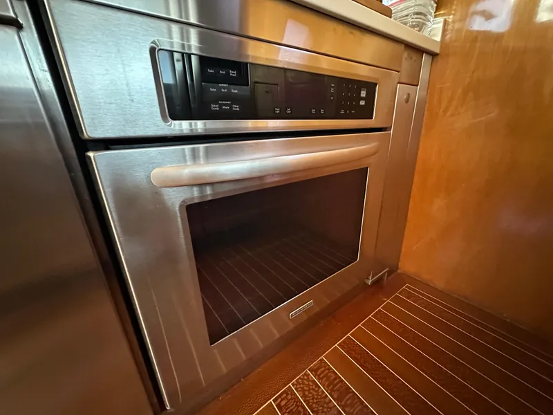 Slide: The Image of Stainless steel oven in a 2000 Mikelson 61 Sportfisher yacht kitchen. - 24