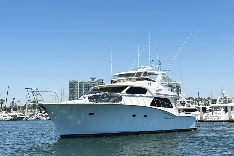 Slide: The Image of Mikelson 61 Sportfisher 2000 yacht on water, clear sky, marina background. - 3