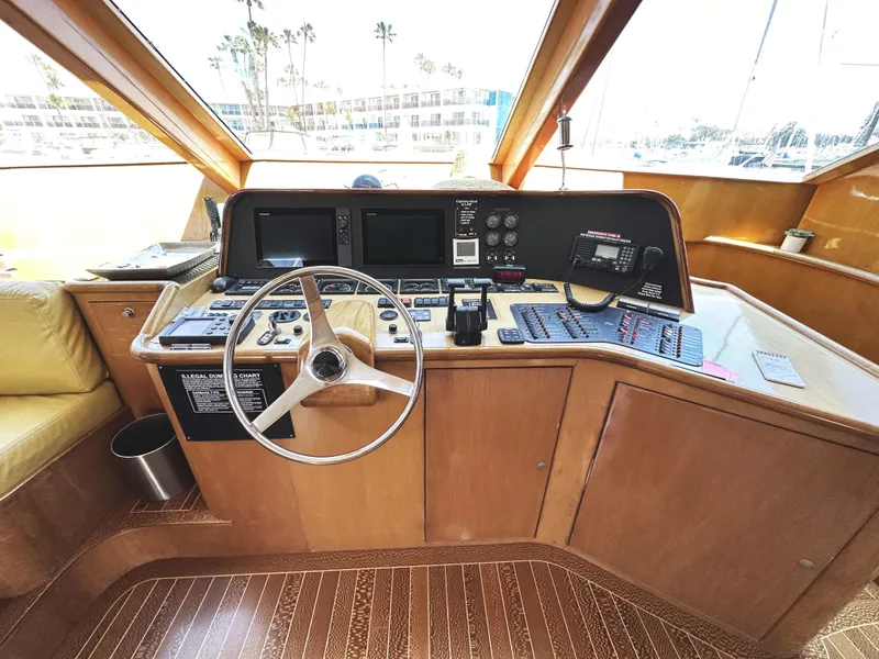 Slide: The Image of Helm of 2000 Mikelson 61 Sportfisher with steering wheel and navigation controls. - 30