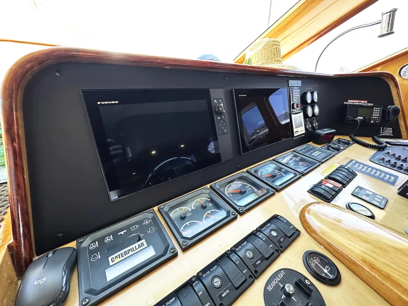 Slide: The Image of Control panel of 2000 Mikelson 61 Sportfisher with navigation screens and gauges. - 31