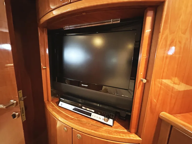 Slide: The Image of Built-in TV and DVD player in 2000 Mikelson 61 Sportfisher yacht's wooden cabinet. - 40