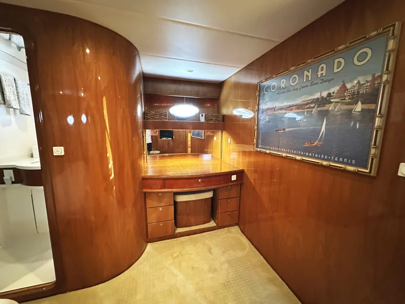 Slide: The Image of Luxurious interior of 2000 Mikelson 61 Sportfisher yacht with wood paneling and Coronado artwork. - 41