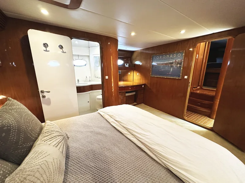 Slide: The Image of Luxurious cabin interior of 2000 Mikelson 61 Sportfisher yacht with wood paneling and cozy bedding. - 42