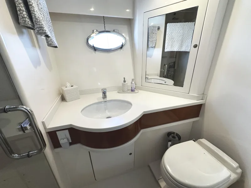 Slide: The Image of Bathroom interior of 2000 Mikelson 61 Sportfisher yacht, featuring sink and toilet. - 43