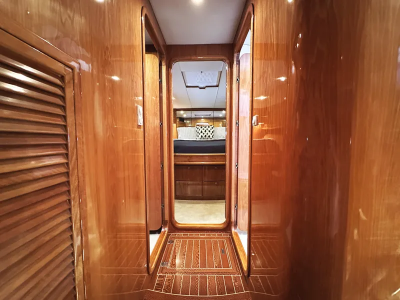 Slide: The Image of Luxurious wooden interior of a 2000 Mikelson 61 Sportfisher yacht cabin hallway. - 45