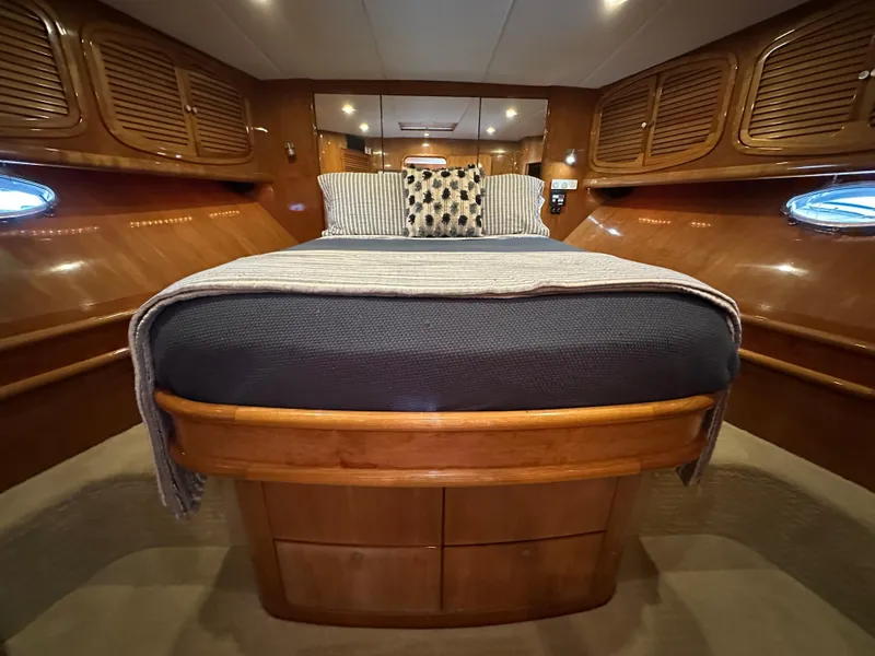 Slide: The Image of Luxurious cabin interior of 2000 Mikelson 61 Sportfisher yacht with cozy bed and wooden finish. - 47