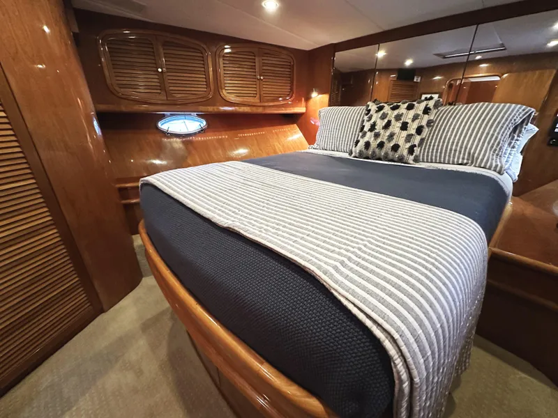 Slide: The Image of Luxurious cabin interior of a 2000 Mikelson 61 Sportfisher yacht with elegant bedding. - 49