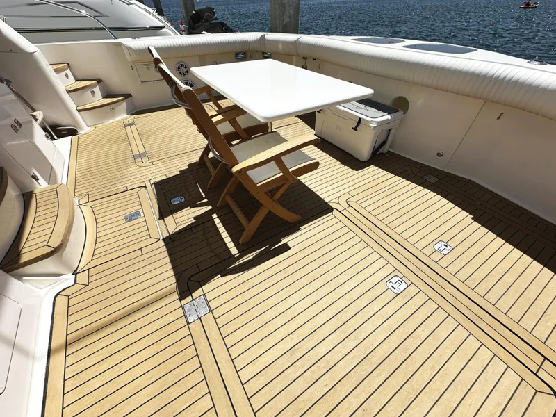 Slide: The Image of Spacious deck of 2000 Mikelson 61 Sportfisher with wooden flooring and seating area. - 6