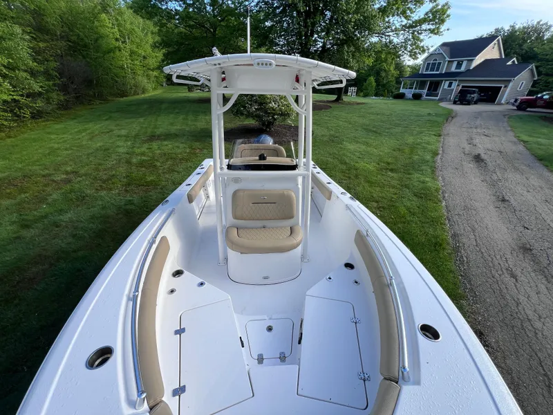 Slide: The Image of 2019 Sportsman Heritage 211 Center Console boat on grassy driveway near house. - 4