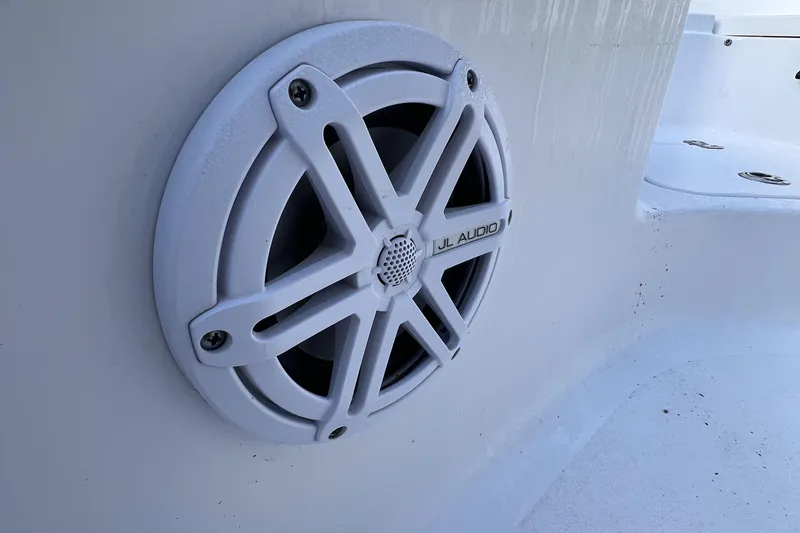 Slide: The Image of White JL Audio speaker on 2019 Sportsman Heritage 211 Center Console boat. - 8