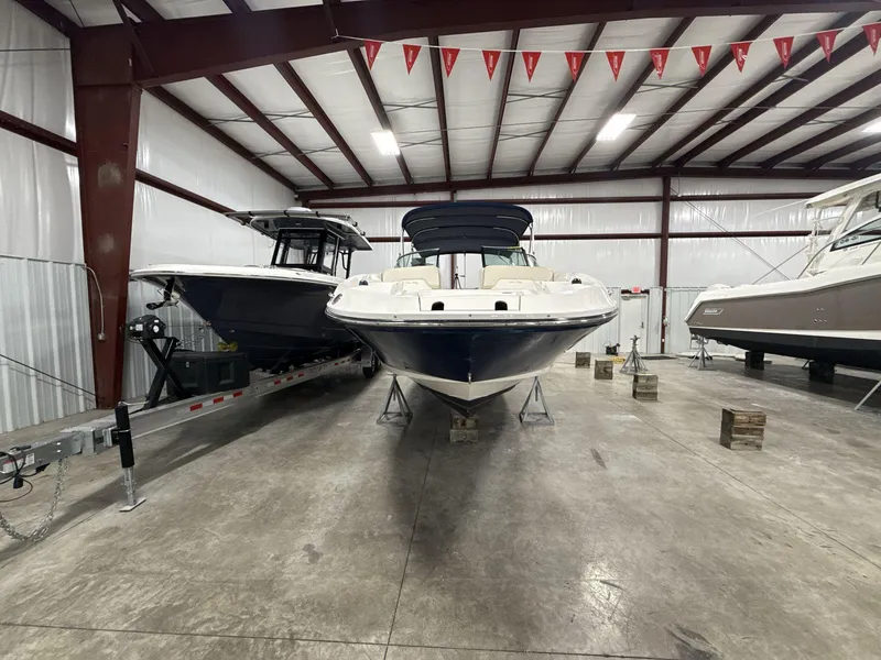 Slide: The Image of 2013 Sea Ray 300 Sundeck boat in indoor storage facility. - 2