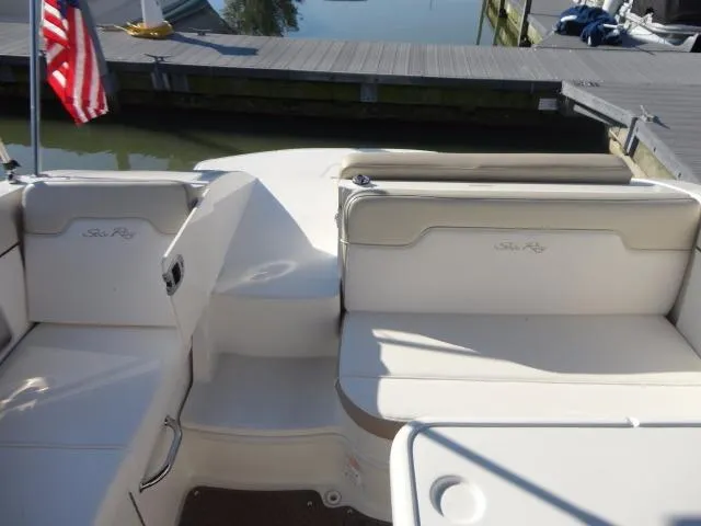Slide: The Image of 2013 Sea Ray 300 Sundeck boat interior with seating and dock view. - 22