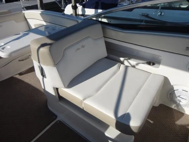 Slide: The Image of 2013 Sea Ray 300 Sundeck interior seating with beige upholstery and sleek design. - 25