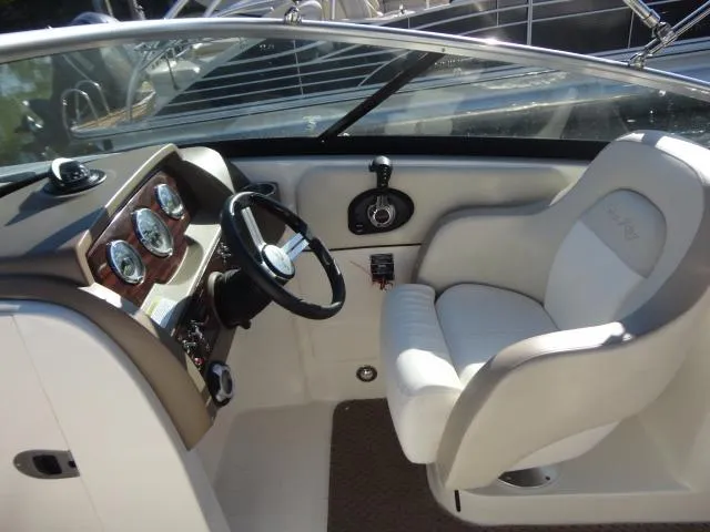 Slide: The Image of 2013 Sea Ray 300 Sundeck cockpit with steering wheel and gauges. - 26