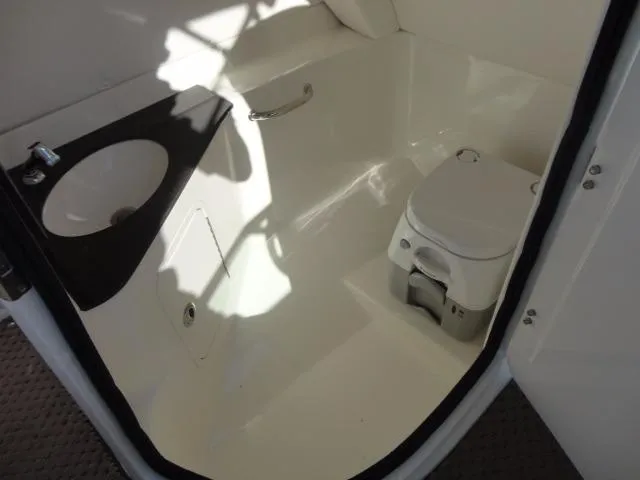 Slide: The Image of 2013 Sea Ray 300 Sundeck boat bathroom with sink and portable toilet. - 28