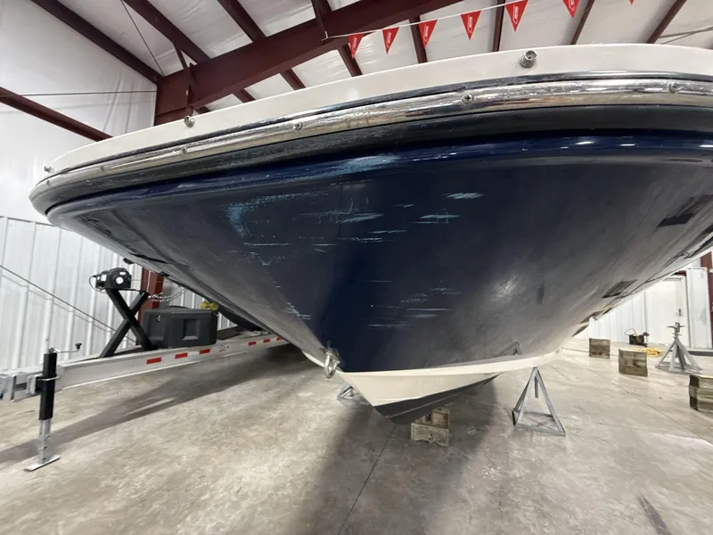 Slide: The Image of 2013 Sea Ray 300 Sundeck boat in storage, showing hull and trailer. - 3