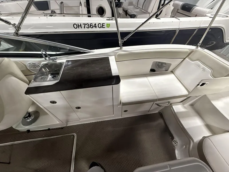 Slide: The Image of 2013 Sea Ray 300 Sundeck interior with sink, seating, and storage. - 8