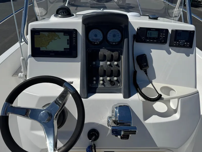 Slide: The Image of 2007 Boston Whaler 200 Dauntless dashboard with steering wheel, gauges, and navigation equipment. - 12