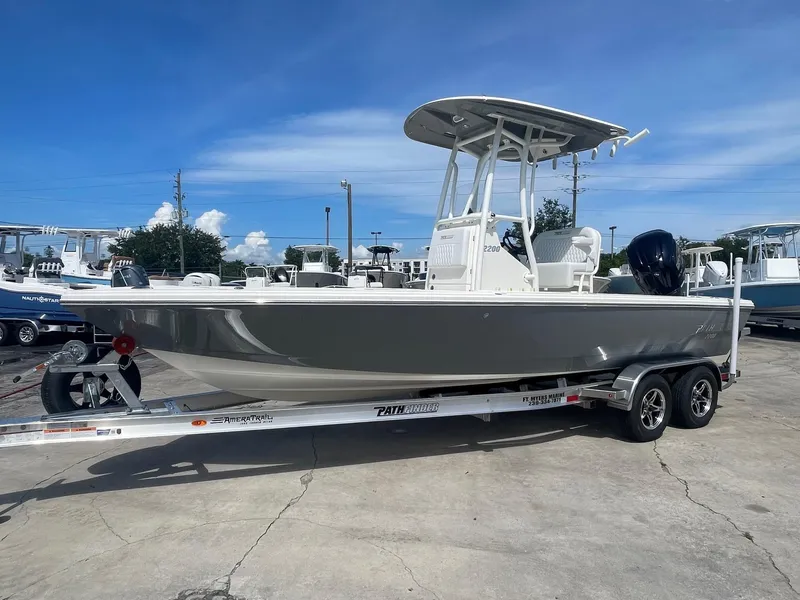 The Image of 2025 Pathfinder 2200 TRS boat on trailer under clear blue sky. - 0