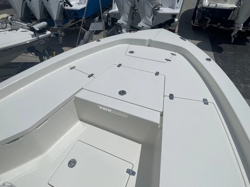 Slide: The Image of 2025 Pathfinder 2200 TRS boat deck with storage compartments, displayed outdoors. - 11