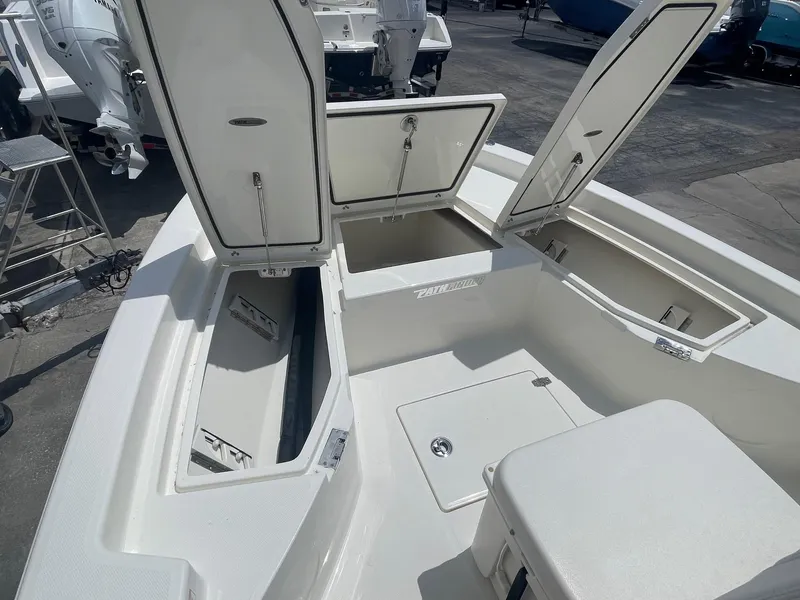 Slide: The Image of 2025 Pathfinder 2200 TRS boat with open storage compartments on deck. - 12