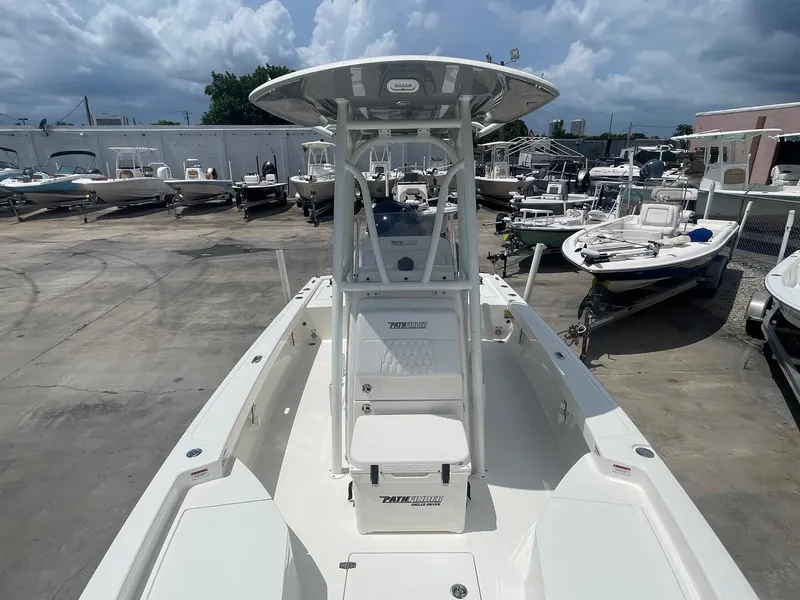 Slide: The Image of 2025 Pathfinder 2200 TRS boat in a marina, surrounded by other vessels under a cloudy sky. - 13