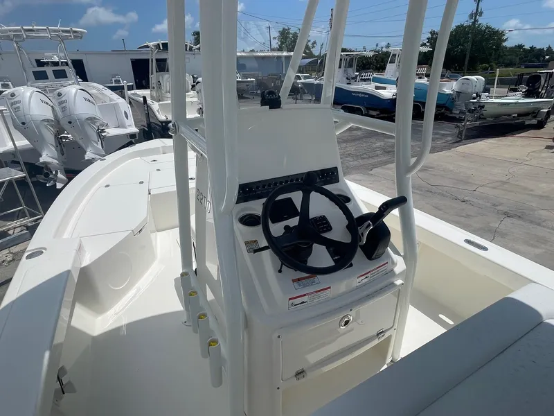 Slide: The Image of 2025 Pathfinder 2200 TRS boat with steering console, docked in a marina. - 4