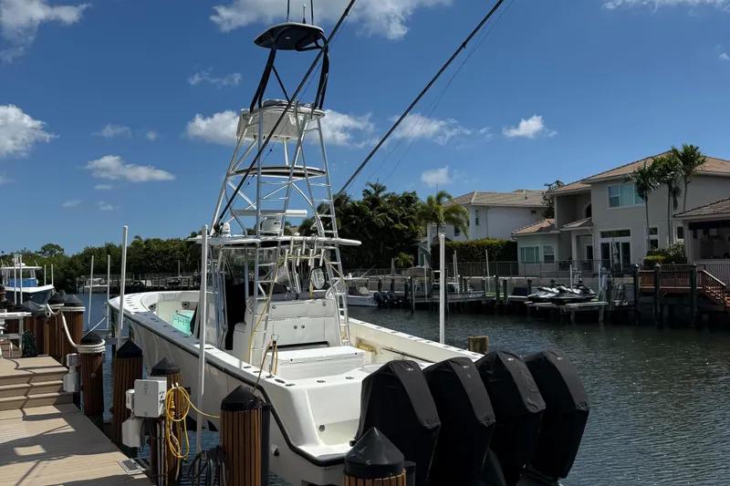 Slide: The Image of 2018 SeaVee 390Z boat docked in a sunny residential canal. - 12