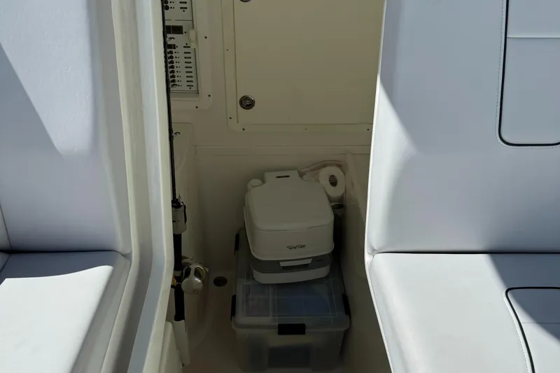 Slide: The Image of 2018 SeaVee 390Z interior storage area with portable toilet and containers. - 14