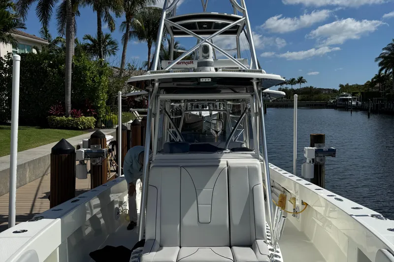 Slide: The Image of 2018 SeaVee 390Z boat docked by a tropical waterfront with palm trees. - 15