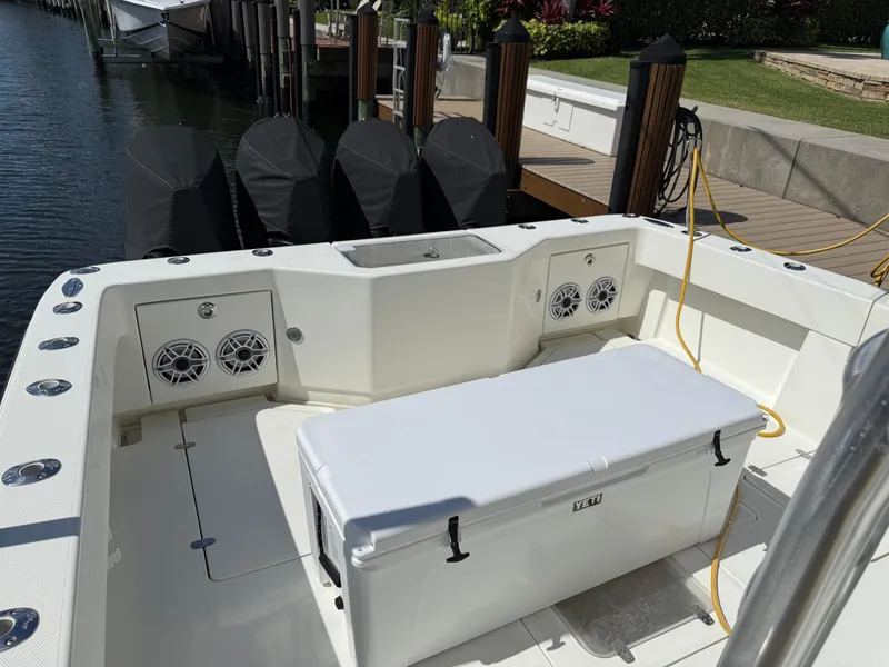 Slide: The Image of 2018 SeaVee 390Z boat deck with cooler, speakers, and docked engines. - 16