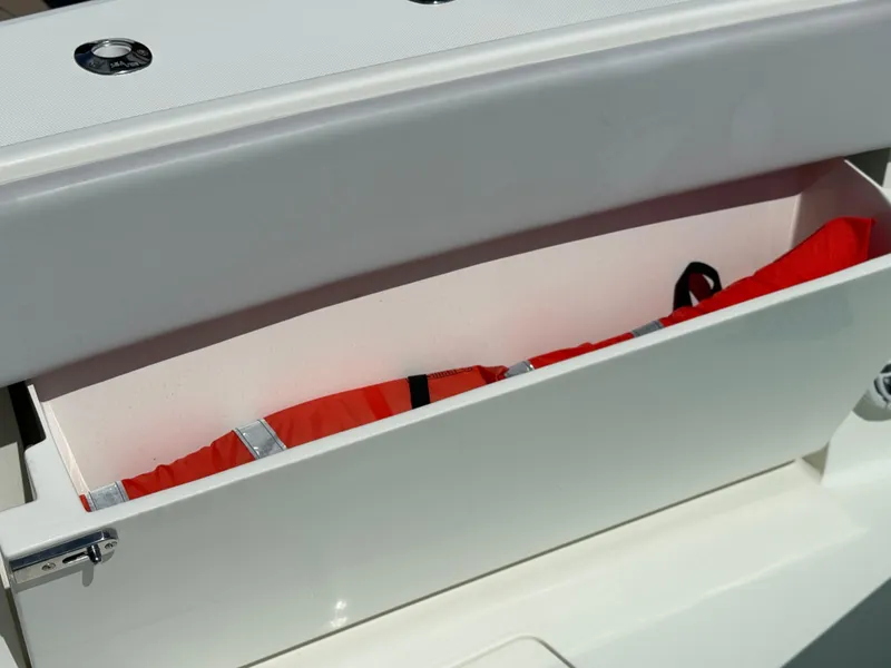 Slide: The Image of Storage compartment on 2018 SeaVee 390Z boat with red life jacket inside. - 4