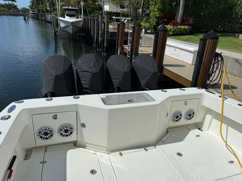 Slide: The Image of 2018 SeaVee 390Z boat with quad engines docked by a waterfront. - 9