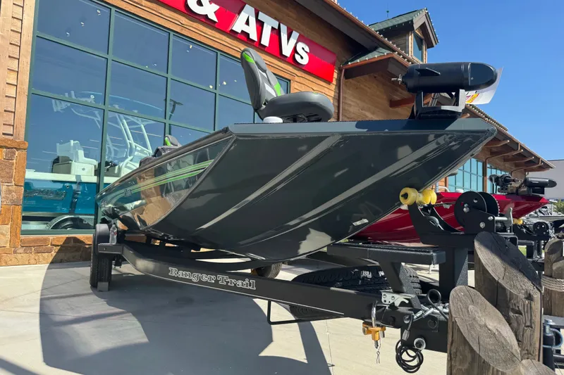 Slide: The Image of 2025 Ranger RT188 boat on trailer outside dealership, showcasing sleek design and modern features. - 19