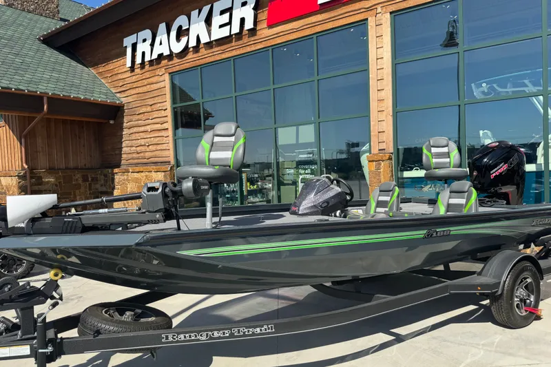 The Image of 2025 Ranger RT188 boat displayed outside Tracker store, featuring sleek design and modern seating. - 18