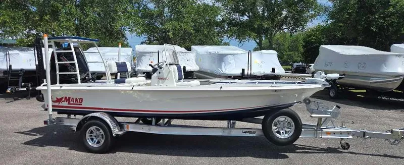 The Image of 2025 Mako 18 Pro Skiff Patriot Edition on trailer, parked outdoors. - 0