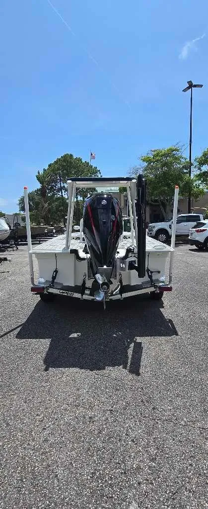 Slide: The Image of 2025 Mako 18 Pro Skiff Patriot Edition boat, rear view in parking lot. - 5