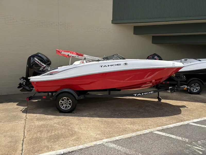 The Image of 2025 Tahoe T16 boat with red and white design on a trailer. - 0