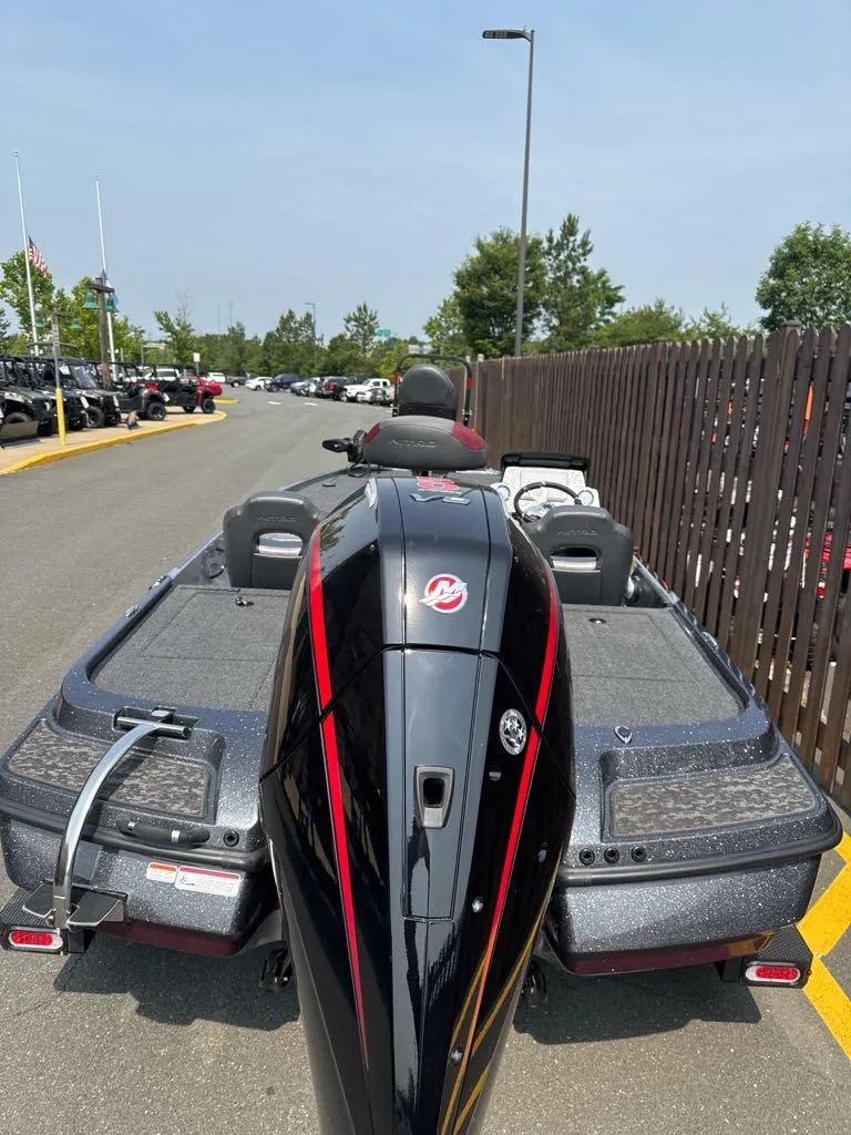 Slide: The Image of 2025 Nitro Z20 XL Pro boat, rear view, parked outdoors on a sunny day. - 4