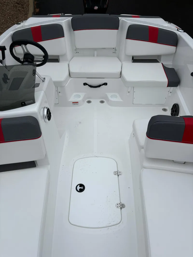 Slide: The Image of 2025 Tahoe T18 boat interior with white and gray seating, steering wheel, and storage compartment. - 3