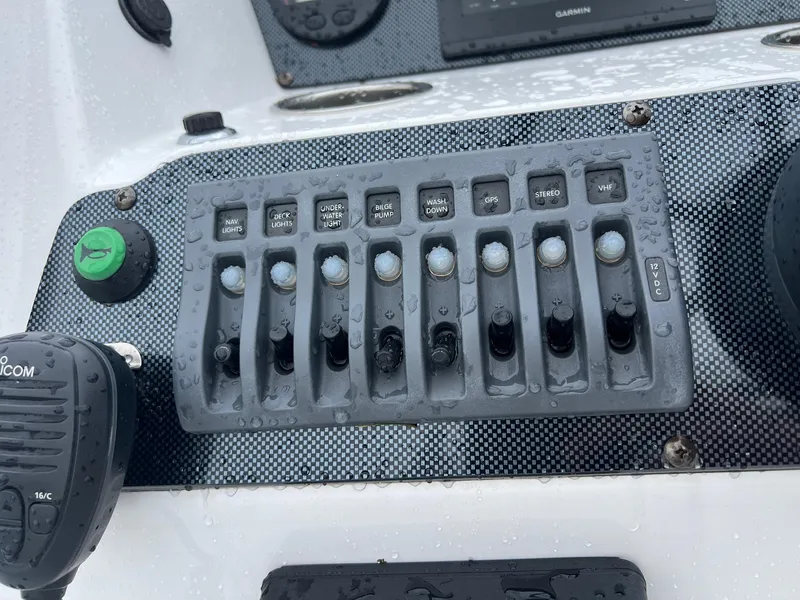 Slide: The Image of Control panel of a 2024 Novurania DL 550 boat with switches and a radio. - 12