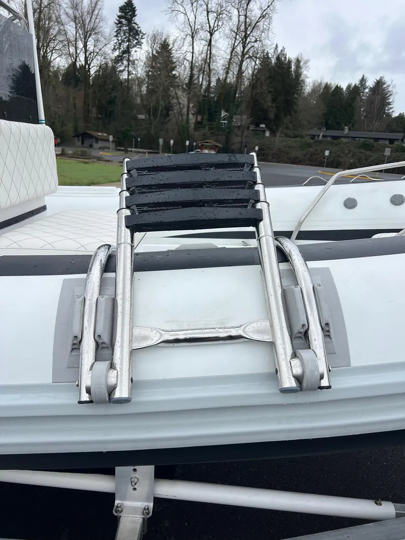 Slide: The Image of 2024 Novurania DL 550 boat ladder on deck, surrounded by trees. - 15