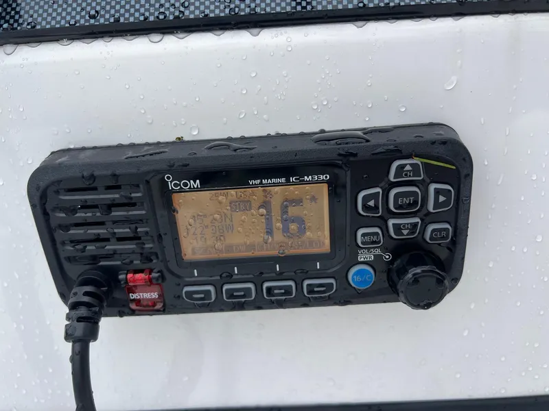 Slide: The Image of VHF marine radio on 2024 Novurania DL 550, displaying channel 16, with water droplets. - 20