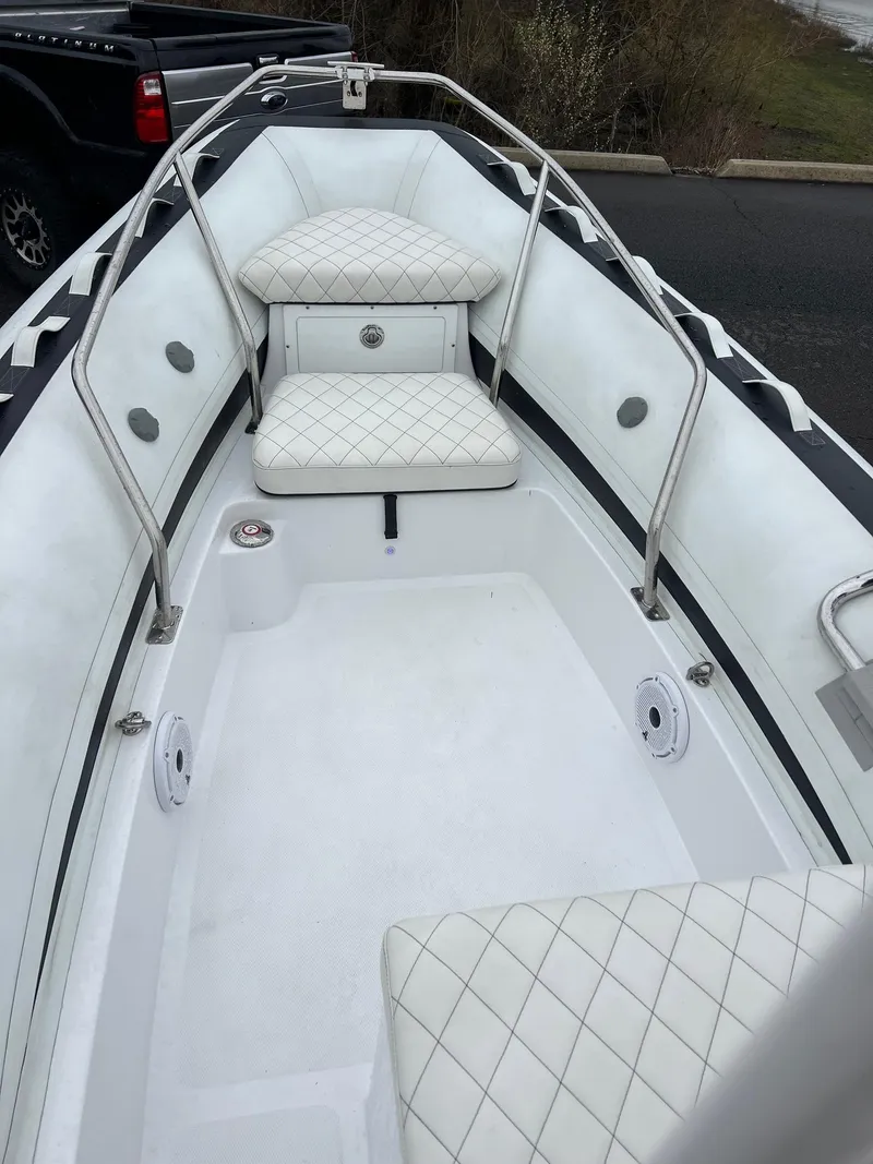 Slide: The Image of 2024 Novurania DL 550 boat interior with white quilted seating and stainless steel railings. - 23