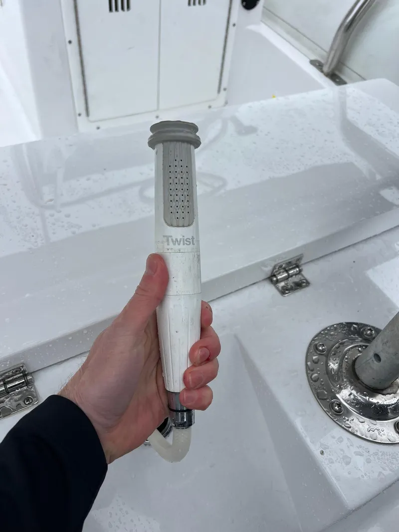 Slide: The Image of Hand holding a twist handle on a 2024 Novurania DL 550 boat deck. - 30