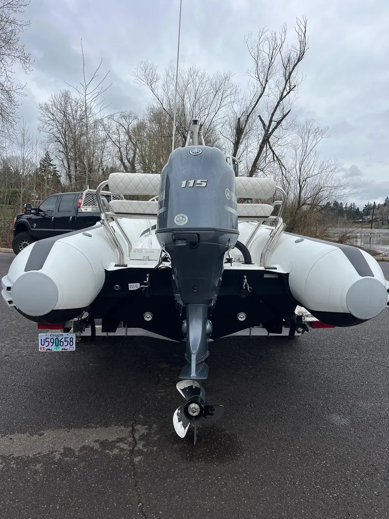 Slide: The Image of 2024 Novurania DL 550 boat with outboard motor, parked on a cloudy day. - 32