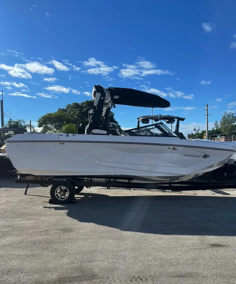 Slide: The Image of 2022 Nautique Super Air G23 boat on trailer under clear blue sky. - 5
