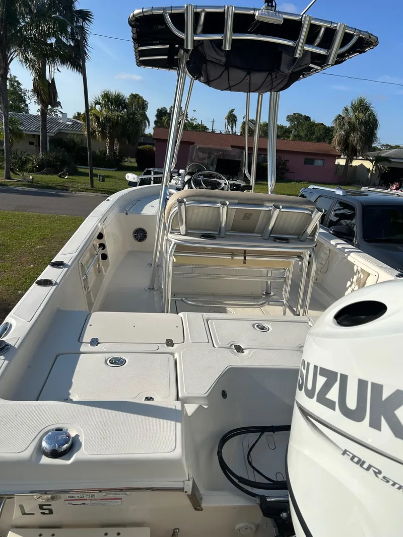 Slide: The Image of 2023 Sea Chaser 23 LX Bay Runner boat with Suzuki engine, parked outdoors. - 3