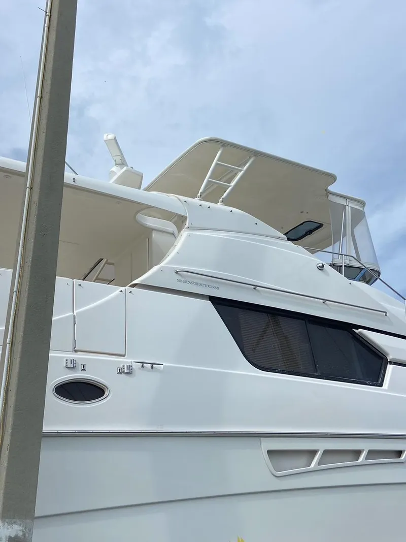 Slide: The Image of 1999 Silverton 453 Motor Yacht with sleek white exterior and modern design. - 12